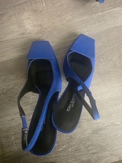 These are Tony Bianco royal blue slingback heels featuring a square toe design and a square decorative button on the vamp [5.1, 5.2, 5.8].Material: Su