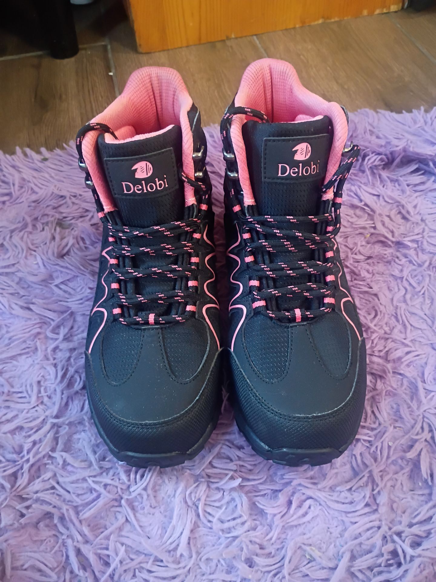 Delobi brand women's black and pink steel-toed work boots.