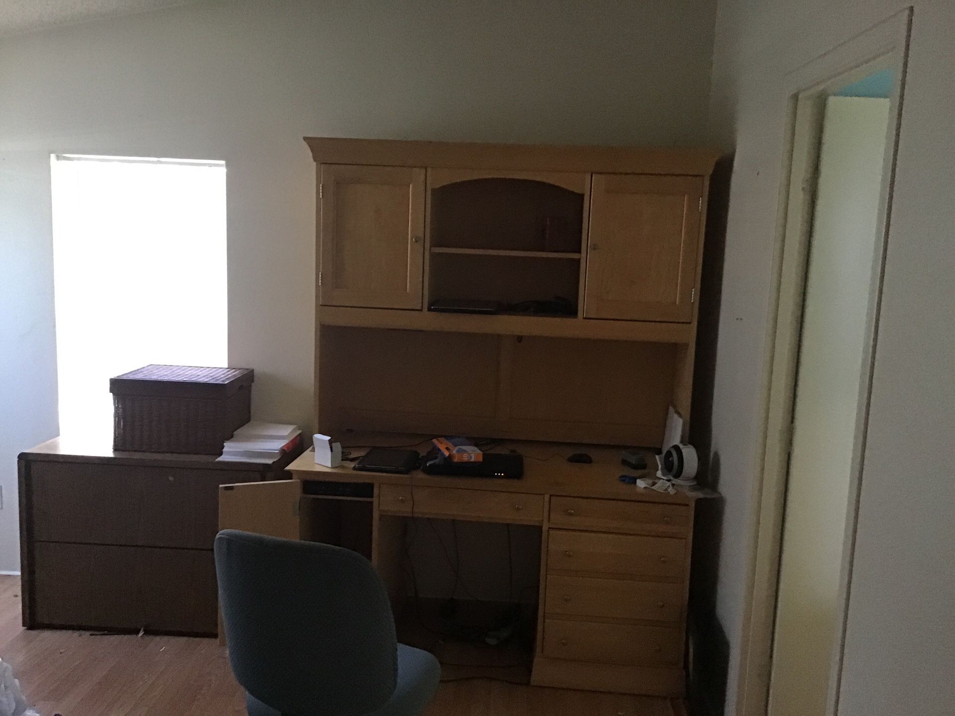 Computer desk with upper cabinets and shelving storage.