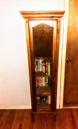 Solid wood shelving unit with door has spacious storage.