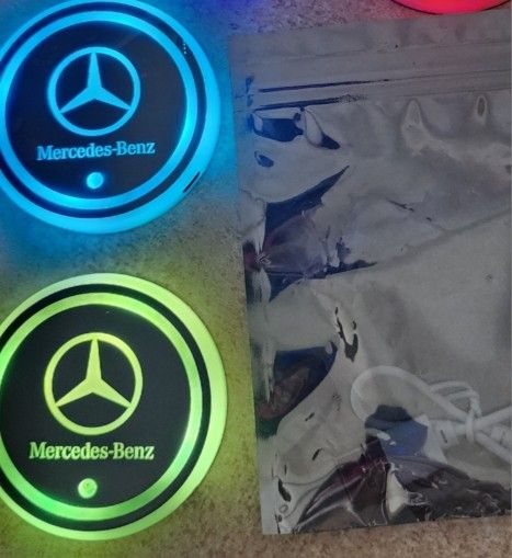 Mercedes, Lexus, BMW or Cadillac Led Color Changing USB charged Car Cupholder Coasters.  Colors slowly fade from one color to the next.