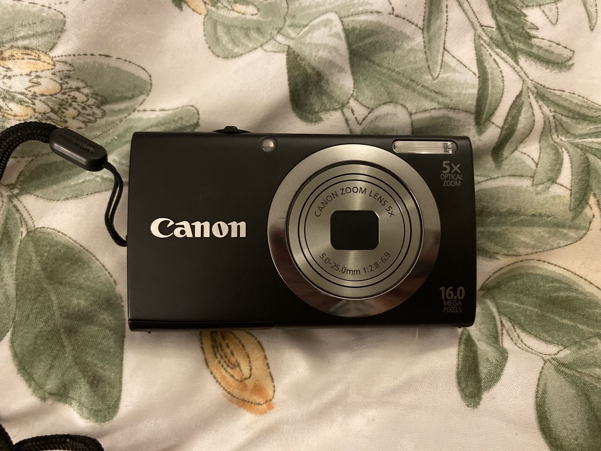 Canon Camera with 2 rechargeable batteries, Battery Charger, an Adapter, and a Case
