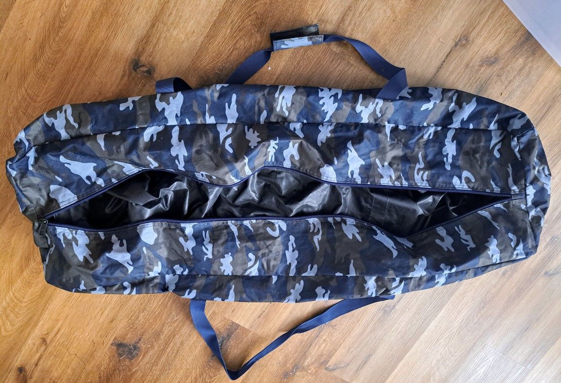 The XL Zippered Duffel Bag in blue camouflage is a water-resistant travel bag designed for men. Made from a combination of polyester and canvas, this