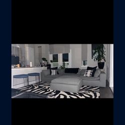 Rug couch, pillows, another rug