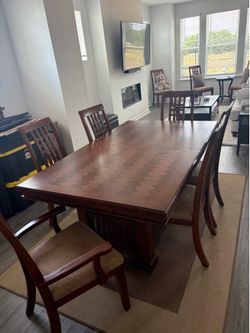 Beautiful solid wood dining table with 2 leafs and 10 chairs included