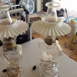 Set of two vintage clear glass lamps with milk glass shades