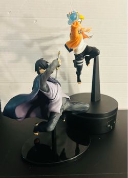 Sasuke and boruto statues