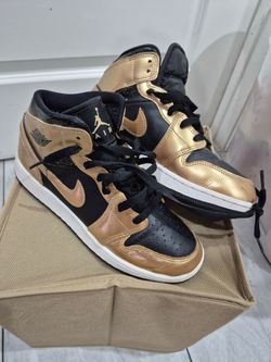 Black and gold Nike shoes youth