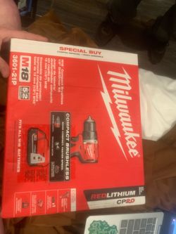Milwaukee compact drill with battery charger battery and a bag