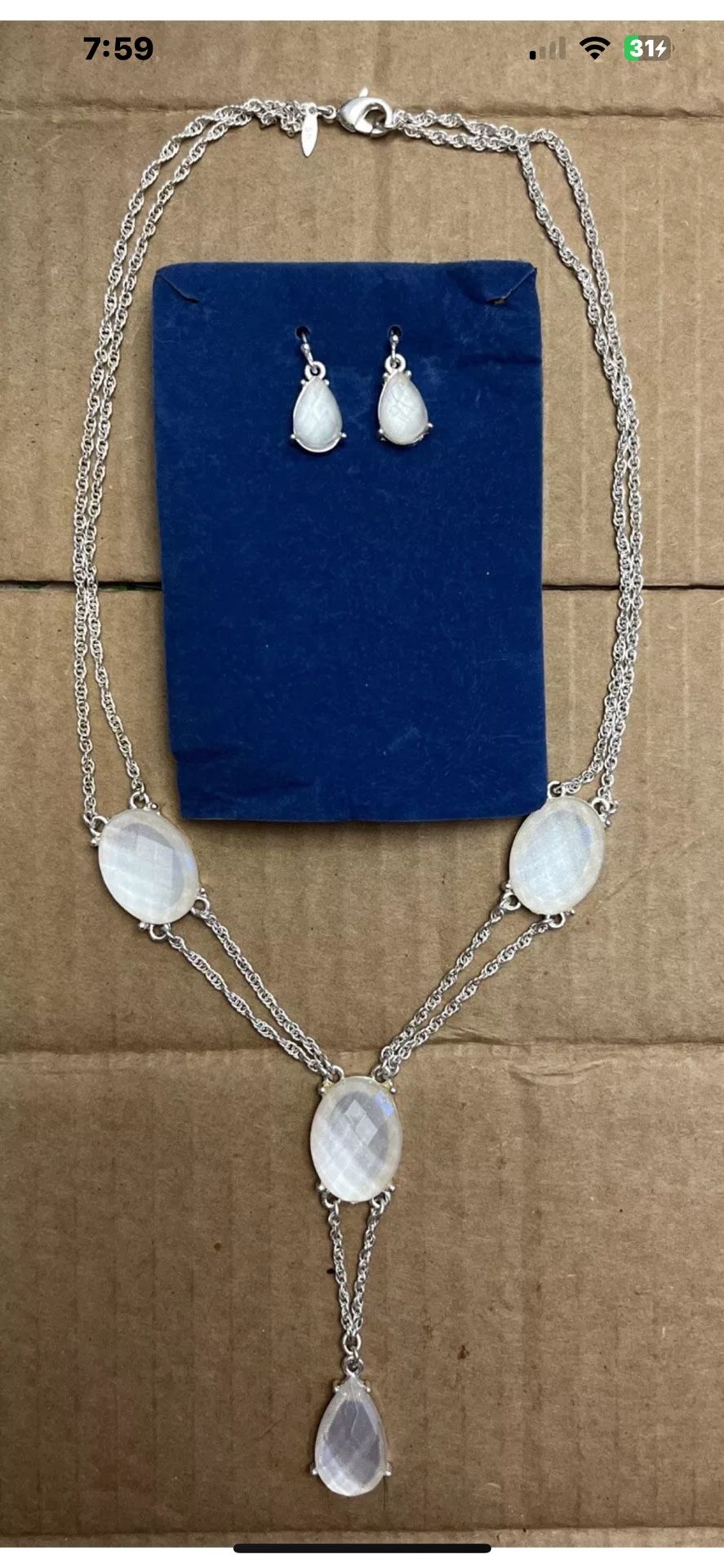 Silver toned Y-drop multi-strand necklace with clear rhinestones and matching earrings.