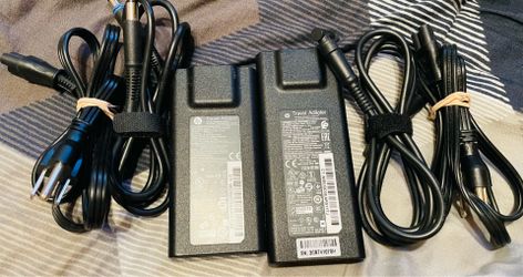 Lot of two original HP travel adapters. One is 65 W one is 90 W one has the normal big barrel connection and one has the small blue tip connection. Th