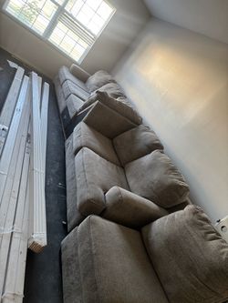 Gray L-shaped sectional with matching pillows from TheRoomPlace