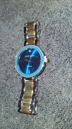 This is an Anne Klein diamond accent bracelet watch in a two-tone silver and gold finish.