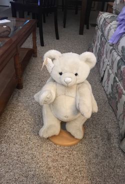 Teddy bear on stand , turn tail makes music