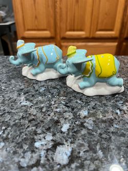 Ceramic Disney Dumbo The Flying Elephant pair of Salt and Pepper Shakers.  Brand new never used.  With original packaging/ box.  Has been on display i