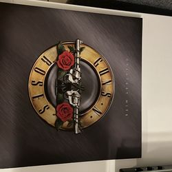 Audio technica record player with two book shelf speakers and guns and roses vinyl record 