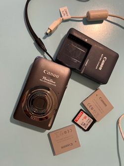 Canon Elph 100HS Powershot camera with accessories
