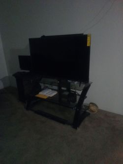 Large Flat Screen TV with Black Glass Stand