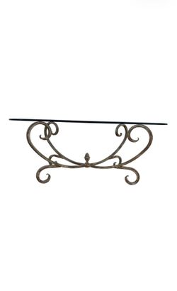 Vintage Hollywood Regency style coffee table featuring a gold-finished wrought iron base with scrollwork and an oval beveled glass top