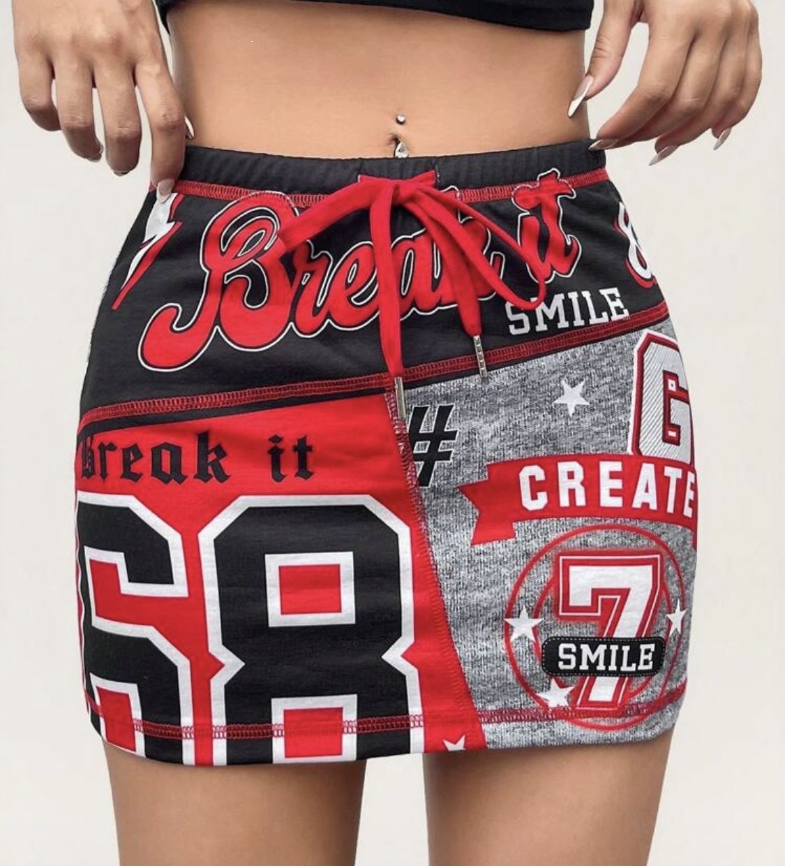 SHEIN Red and Black Graphic Mini Skirt Bold mini skirt with graphic print. Features red and black design. Perfect for a trendy look.