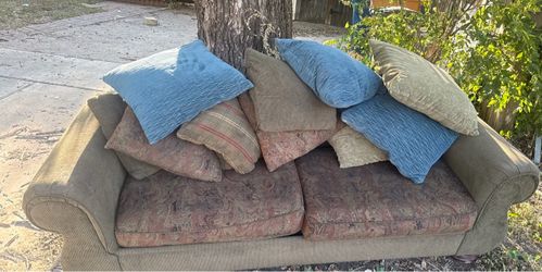 FREE couchbed sitting in front of house