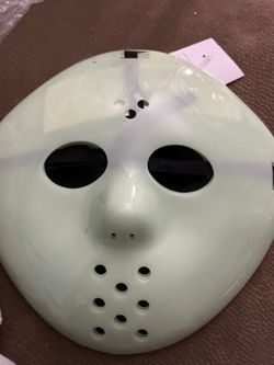 light green or glow-in-the-dark plastic hockey mask that resembles the iconic style of Jason Voorhees from Friday the 13th.