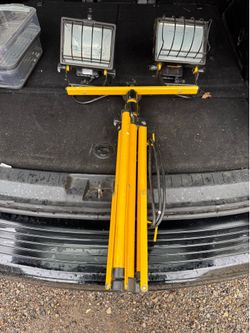 corded electric dual-head halogen work light with a telescoping tripod stand