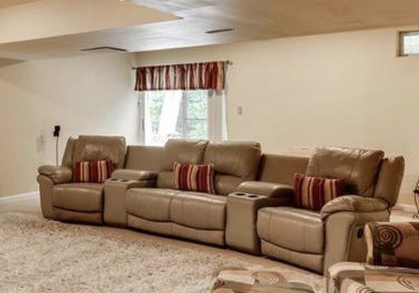 Leather Theatre chairs with recliners on each end and leather arm rests/cup holders