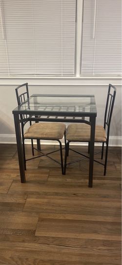 Metal and glass table with chairs