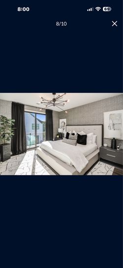 Bed and side tables with plant and lamps
