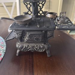 Miniature Crescent cast iron stove  And Several Porcelain Dolls
