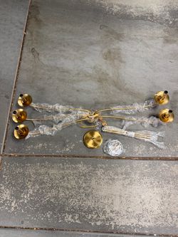 Gold-finish modern farmhouse candle-style chandelier, featuring slender curved arms and multiple light sockets.