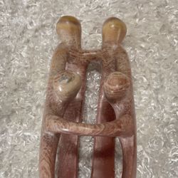 hand-carved Kisii stone sculpture of loving parents and children.