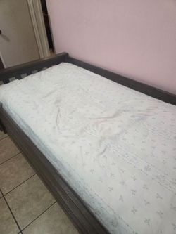 Twin sized mattress with wood bed frame