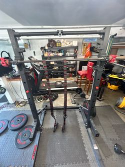 Ethos squat rack with weights and straps and bar