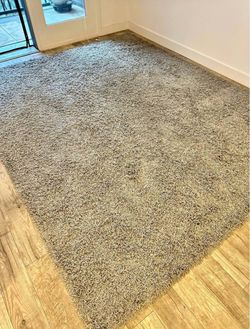 Two 8’ x10’ synthetic gray shag rugs