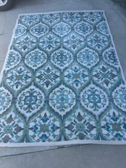 Beautiful Area Rug Made in Turkey 6'7" X 9'3' by Claremont. Blue, green and brown against a cream /beige background.