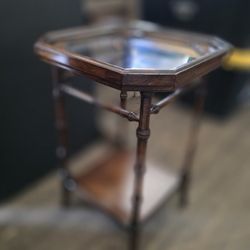 faux bamboo side table with a glass top 