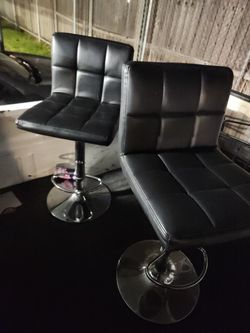 2 black faux-leather adjustable bar stools counter