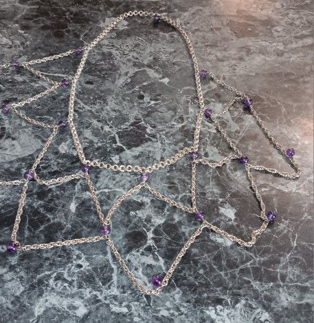 The item shown in the image is a beaded body chain or a chain net top.