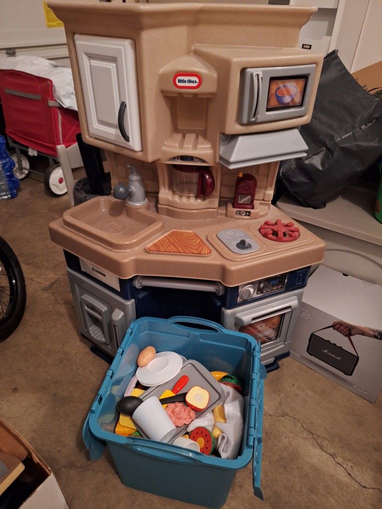 Little Tikes Kid's Kitchen with a set of plastic foods