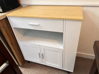 Modern white storage cabinet / kitchen cart with wood top in excellent condition.