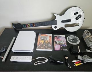 Nintendo Wii and 2 guitar hero games bundle