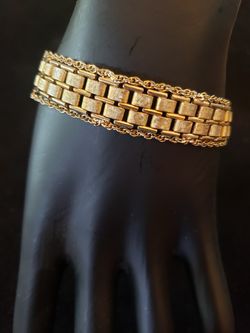 $15. Vintage Goldette NY gold tone bracelet. 7 inches long. 1/2 inch wide. Has a safety chain.