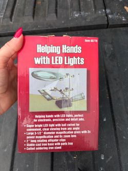 A tabletop magnifier holder called “Third Hand” with a light, designed for soldering, electronics repair, and other precise small‑scale tasks.