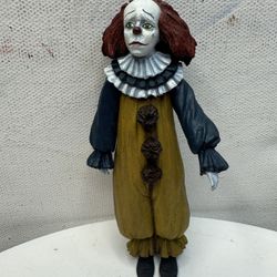 This is a collectible figurine of Pennywise the clown from the movie "It".