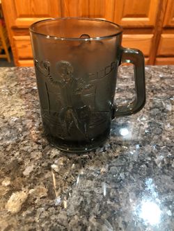 Vintage McDonald’s Gray Smoke Mug Glass.  Ronald McDonald with a Football.  Size 4 1/2 inches tall and 3, inches wide across the rim.  Capacity 4 ounc