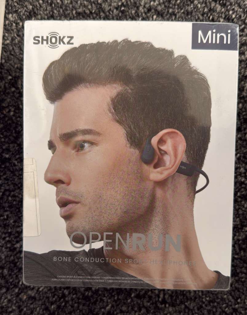 Sealed New Shokz OpenRun Mini bone conduction sport headphones.