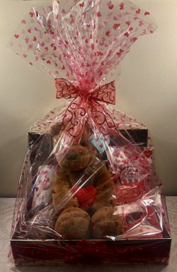 Valentine’s Day gift basket. Stuffed Lion, Hot Chocolate, Heart Travel Mug, Valentine’s Gummies, Chocolate Truffles.