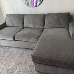 Grey Couch With Reversible Side Ottoman